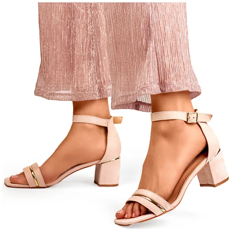 Pink women's low-heeled sandals with ankle fastening